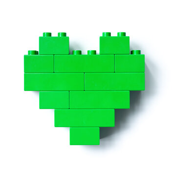 Green heart from Bricks isolated on white background, top view object, design element, figure heart from child Bricks construction. Love concept, Valentines card, Toys, games
