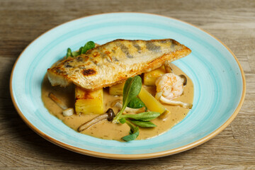 Roasted Zander fish fillet with potatoes and mushroom sauce