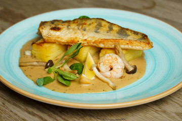 Roasted Zander fish fillet with potatoes and mushroom sauce