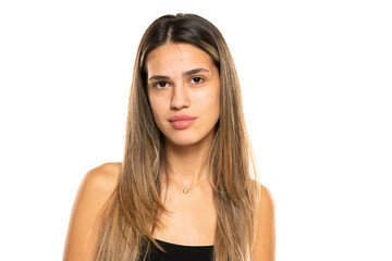 Fototapeta premium beautiful young women with long balayage painted hair and no makeup on a white background.