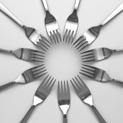 Silver-colored forks arranged in a circle.