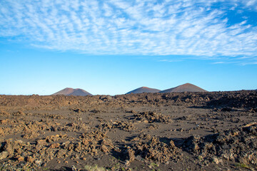 cold lava in detail in Timanfaya national park in Lanzarote with crater landscape