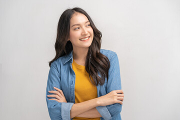 Smile positive, attractive asian young woman wearing yellow casual, portrait of beautiful brunette her with long hair, cute girl feeling happy, standing cross arms chest isolated on white background.