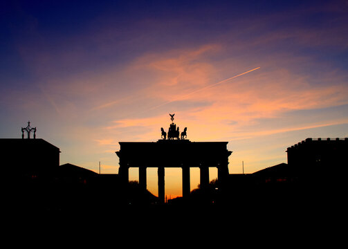 the Brandenburg gate, symbol of the city of Berlin, silhouette at sunset
