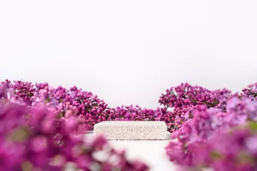 Zelfklevend Fotobehang Cosmetics skin care product presentation scene and display made with pumice stone podium and lilac flowers. Studio photography. © Dmytro