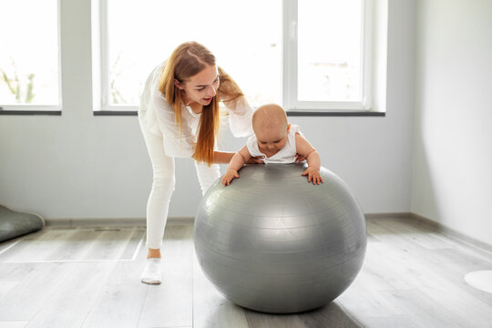 Stability ball exercises for neurodevelopment of baby. Low muscle ball. Tummy time.