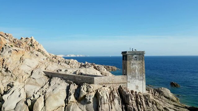 A Mesmerizing Aerial Journey: Passing in Front of The Majestic Lighthouse of Capu di Fenu in Bonifacio, Corsica - Amidst the Rugged Natural Beauty of the Rocky Cliffs of the Coast