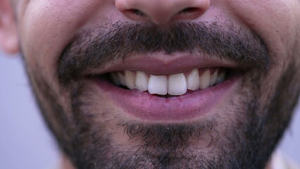 Obraz premium One happy MIddle Eastern man closeup mouth smile in macro. Bearded male person smiling at camera close up detail of teeth