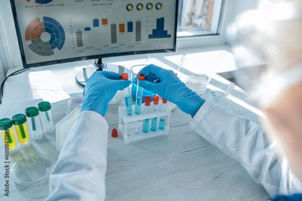 Poster a medical worker performing tests on instruments in a chemical laboratory. a scientist conducting re
