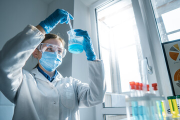 The photo depicts a scientist testing on instruments in a chemical laboratory to develop new methods for diagnosing and treating diseases. Medical professional performing a blood test