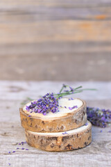 mock-up wooden sawn on a wooden background with a branch of lavender