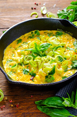 Omelette with Leek and Herbs, Delicious Snack or Breakfast on Rustic Wooden Background