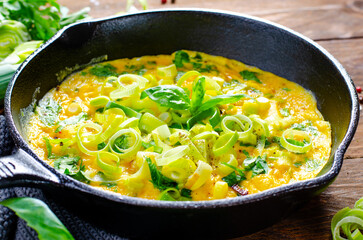 Omelette with Leek and Herbs, Delicious Snack or Breakfast on Rustic Wooden Background