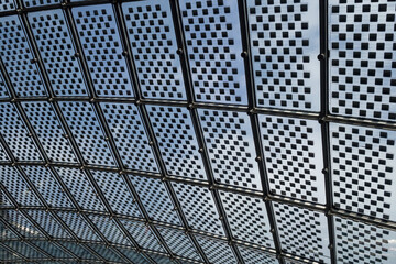 Translucent photovoltaic modules on transparent roof. Modern sustainable technology in architecture. Laminated glass panels with solar cell. Semi-transparent cells in overhead glazing of the building