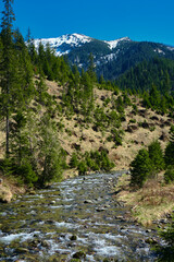 Beautiful spring panorama over river to snowy Witow, Tatra mountains, Poland