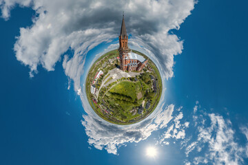 little planet transformation of spherical panorama 360 degrees overlooking church in center of...