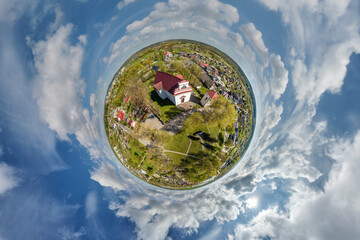 little planet transformation of spherical panorama 360 degrees overlooking church in center of...