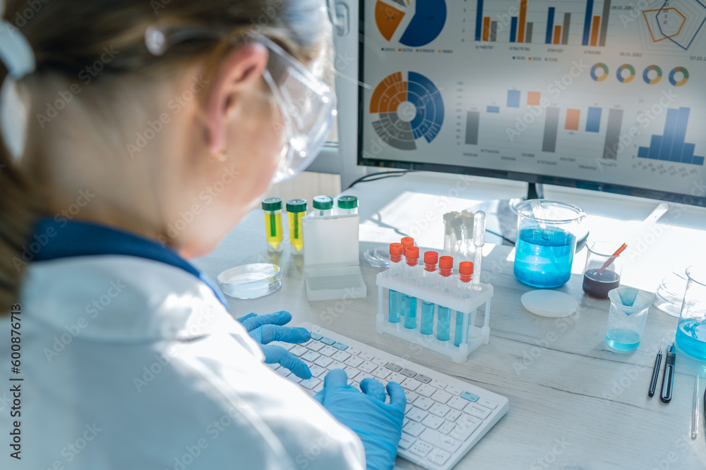 Poster doctor researcher analyzes results his experiments on a computer in chemical laboratory. biotechnolo
