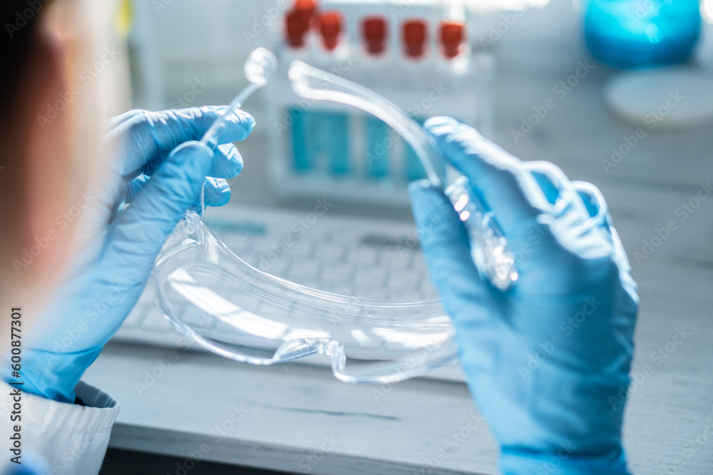 Poster A chemist analyzes the results of an experiment with samples of various drugs on a computer in a medical laboratory.