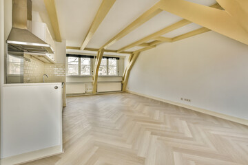 an empty room with wood flooring and white appliances on the wall in this photo is taken from the inside