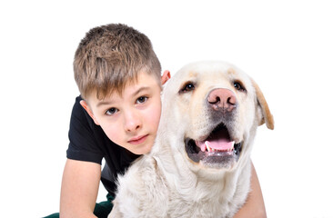 Portrait of cute boy hugging labrador dog isolated on white background