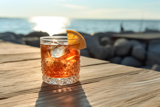 Refreshing Old fashioned cocktail classic bourbon whiskey and bitters, orange peel on wood table in front of blue sky on summer sea. generative ai