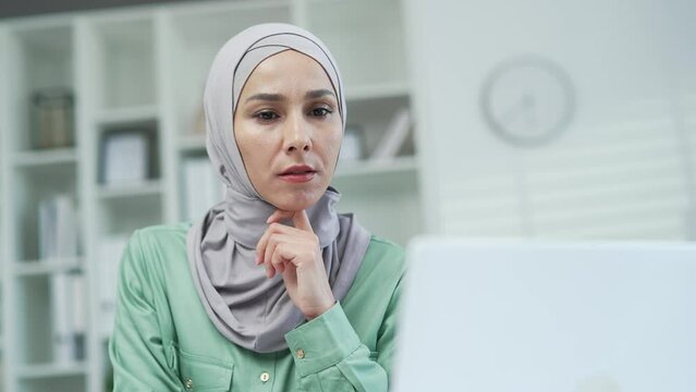 Thoughtful serious worker work on laptop computer in moderm office or home Creative designer architect or freelancer think solving problem look for inspiration feeling lack of ideas at workplace