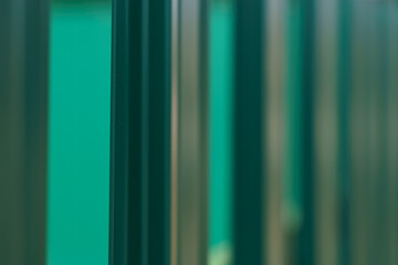 Green profiled fence, side view, close up.