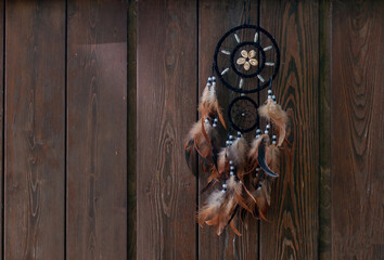 Dreamcatcher, american native amulet on wooden background. Shaman.
