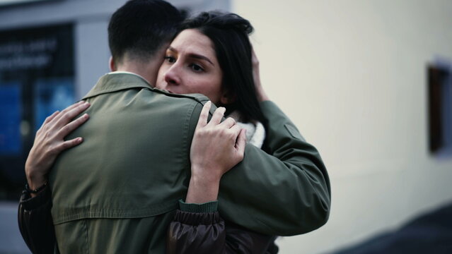 Young Arab man embracing woman standing in city street in empathy. Tracking shot of an affectionate compassionate couple. relationship support and gratefulness concept