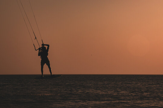 Kitesurfing silhouette with sky background with sunset,