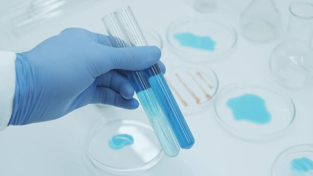 Laboratory chemical test tube and petri dish with blue liquid. Agar or agarose gel containing whatever nutrients organism requires. Mixing medicines. Laboratory tests and results. chemical solution.