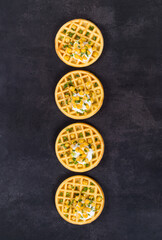 Vegan round Corn waffles. Dark gray background. Top view