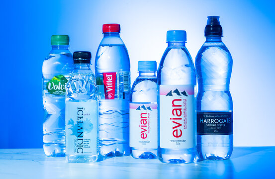 Illustrative editorial of Premium global bottled water: Evian, Icelandic, Volvic, Vittel, Harrogate bottles are on the table: POLTAVA, UKRAINE - May 09, 2023.