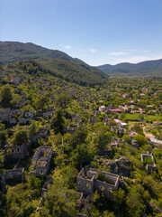 Fototapeta na wymiar Kayaköy, One of the Most Beautiful Settlements in Fethiye. This Is a Greek Village Built on the Settlement of the Lycian Civilization. Drone Camera Soars Over Town.