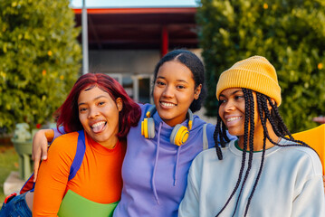 group of three teenage girls, friends and classmate, leaving high school. end of classes friendship and union