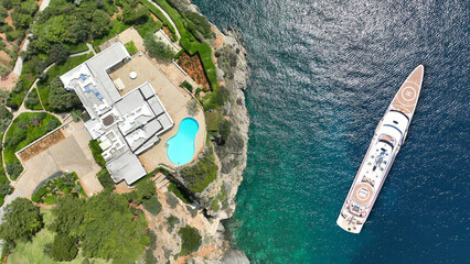 Aerial drone photo of luxury yacht with helipad anchored in tropical exotic island with emerald...