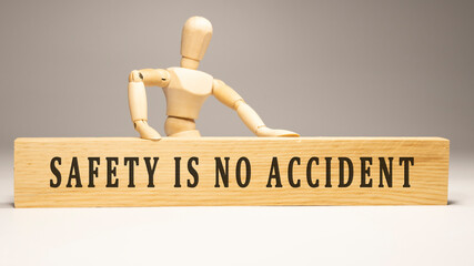Safety is no accident. Written on wooden surface.