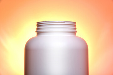 White plastic can against colorful background