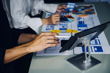 Close up ux developer and ui designer brainstorming about mobile app interface wireframe design on...