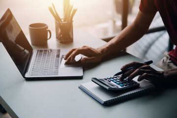 Entrepreneur Asian businessman and businesswoman discussing new business project in tablet in modern Meeting In Modern Office, Asian business casual concept.