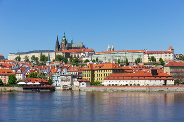Spring colorful Prague Lesser Town with gothic Castle above River Vltava in the sunny Day, Czech...