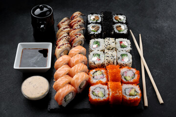 Delicious sushi platter with a variety of rolls and sauces
