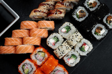 Delicious sushi platter with a variety of rolls and sauces
