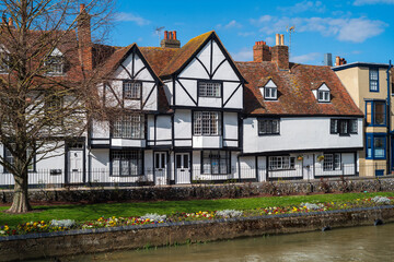 A Tudor style timber building on the bank of the river Stour in Canterbury, Kent, UK on a sunny spring day.