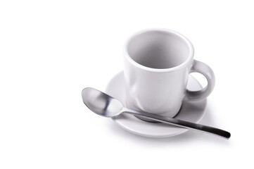 Empty coffee cup saucer and teaspoon isolated on white background, closeup.