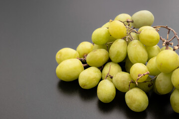 detail of green grapes on dark background, grape concept