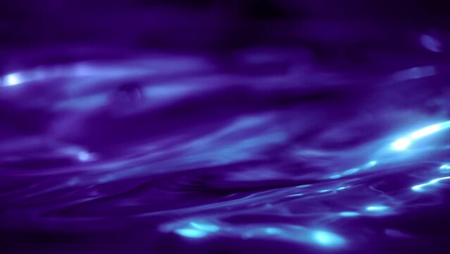 Elegant abstract close-up macro water wave loop background. Purple copy space and showcase mock-up element backdrop. 3D animation of fluid molten shape of liquid shiny indigo ultraviolet oil surface.