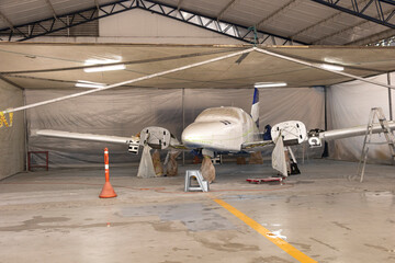 A small plane that is drying after being painted