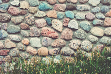 part of the stone fence in close-up. decorative fence made of masonry stones.